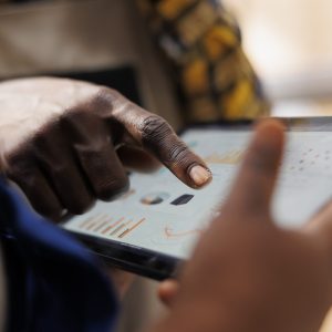 African american warehouse worker hand pointing at inventory statistics on tablet. Storehouse employee asking supervisor about products distribution analytics report and tapping on screen close up
